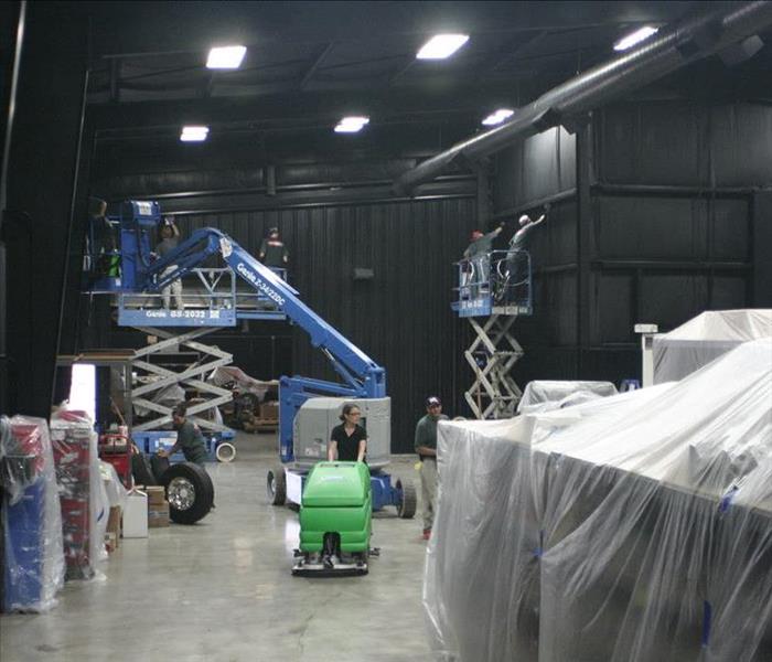 SERVPRO employees cleaning a smoke/soot damaged facilty