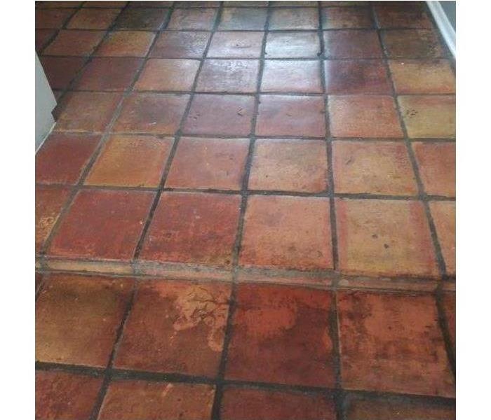 A dirty, aged tile floor.
