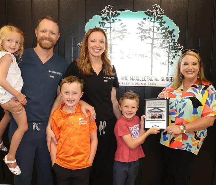 chamber members attend a ribbon cutting for a new business