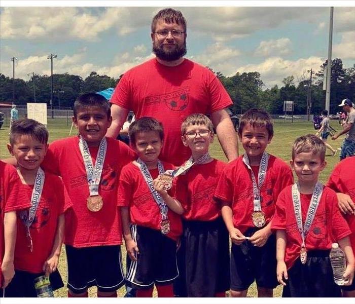 SERVPRO Employee with childrens soccer team