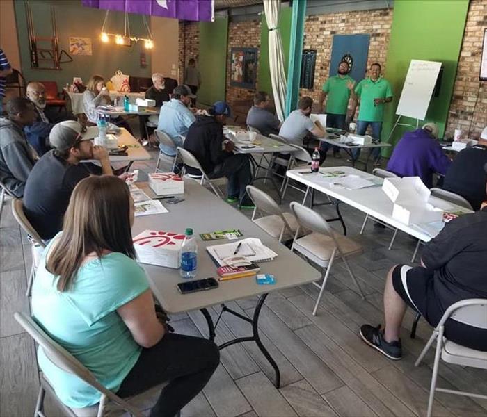 SERVPRO employee with 15 others sitting at pool certification class