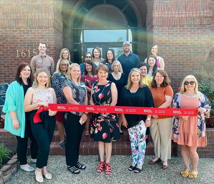 chamber members attend a ribbon cutting for a new business