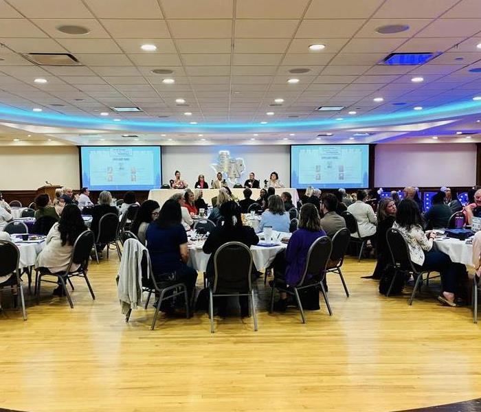 Large crowd of people seated at a conference