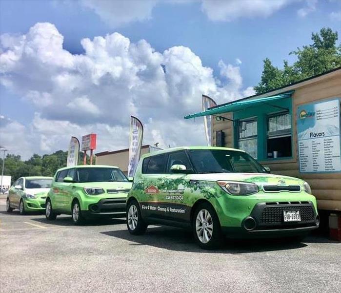 SERVPRO vehicles in a line at a local business.