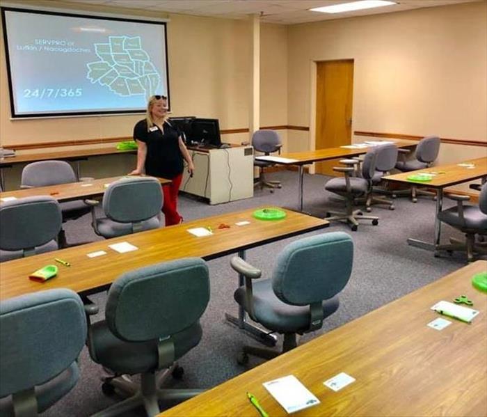 Candice posing in an empty room preparing for a class.