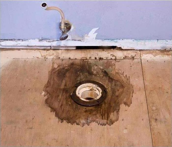 A water damaged drain that has begun to sag.