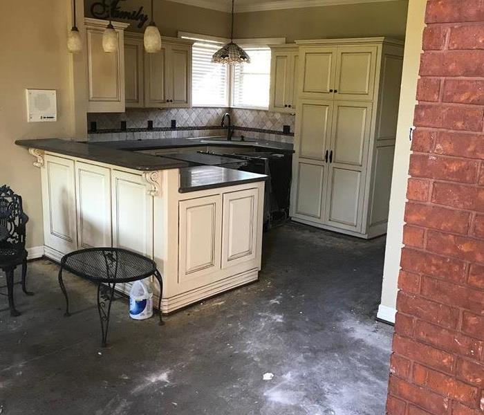 A burned and blackened kitchen after a fire.