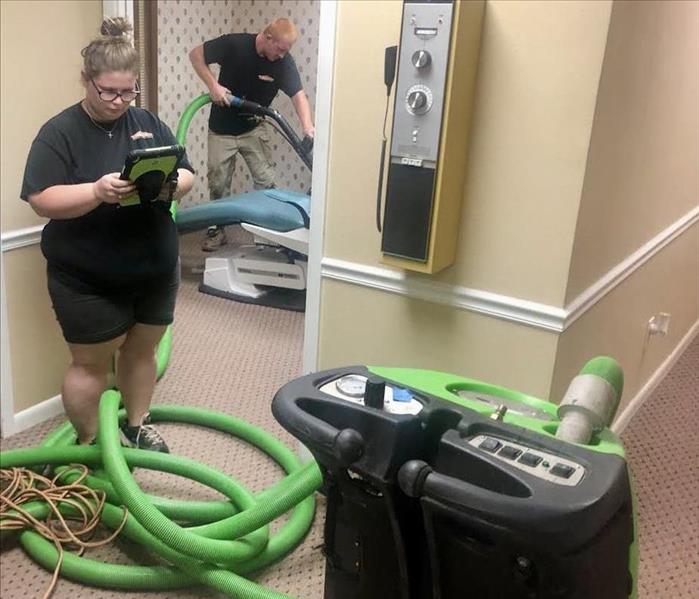 Technicians use extractor to remove water