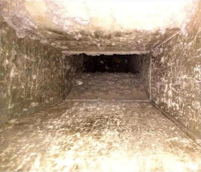 A dirty, unclean air duct filled with mold, dirt, and other harmful things.