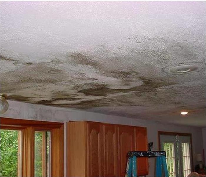 A damaged ceiling of a home after a strong storm.
