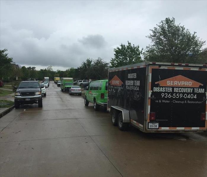 A SERVPRO van in a crowded and busy neighborhood.