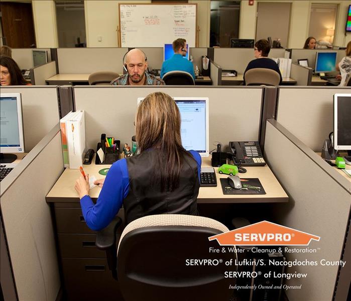 female SERVPRO employee working in cubicle