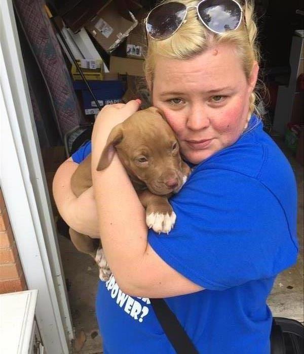SERVPRO employee holding a rescued puppy 