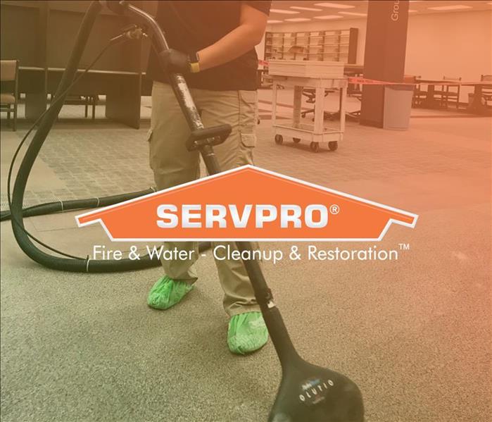 SERVPRO employee cleaning water damage