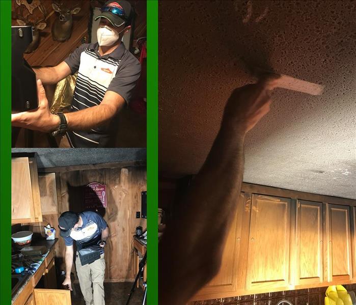 Kitchen fire damage with SERVPRO employee scoping the damage