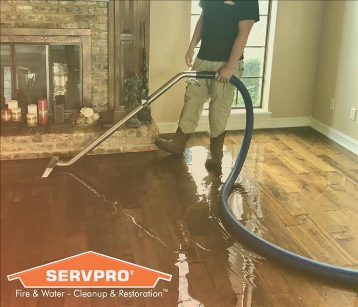 SERVPRO employee cleaning water damage