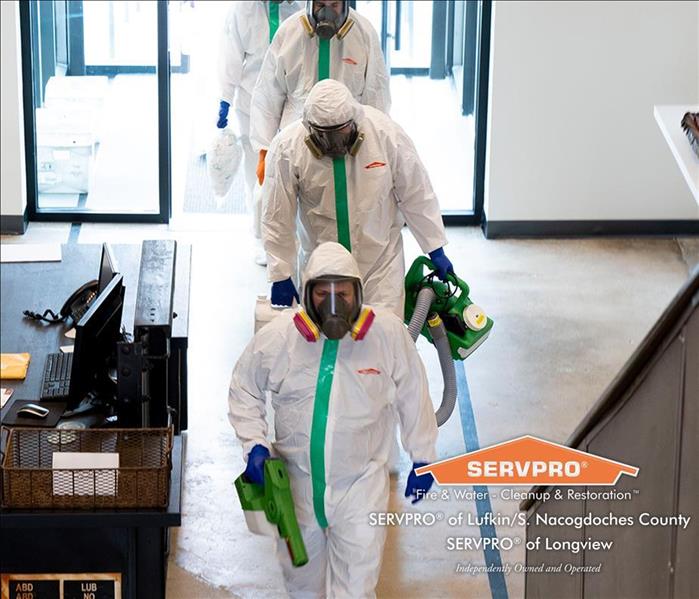 SERVPRO Biohazard specialists walking into a building