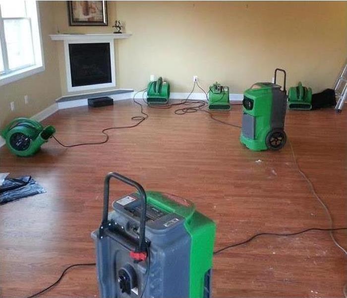 SERVPRO fans in a large room that has been affected by a water leak.