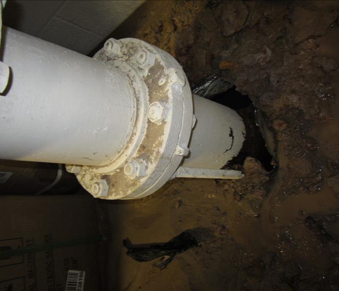 A broken water pipe that is leaking water.