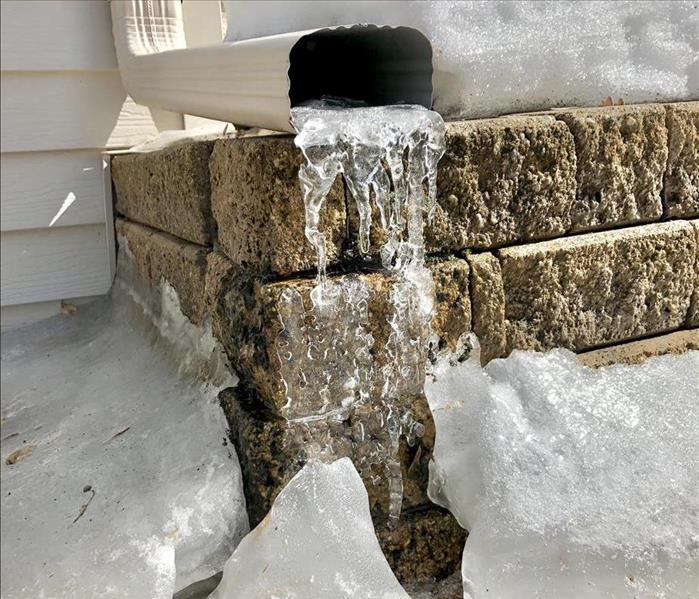 frozen clogged house gutter
