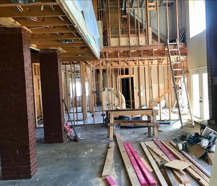 The inside of a two-story home that has been stripped down to it's frame during a rebuild.