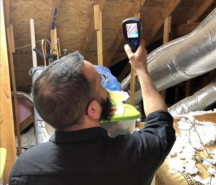 servpro technician using the latest in technology to perform mitigation.